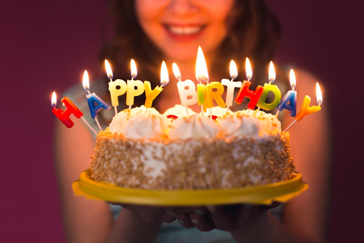hands-of-young-woman-holding-birthday-cake-PAXNLTX (Copy)